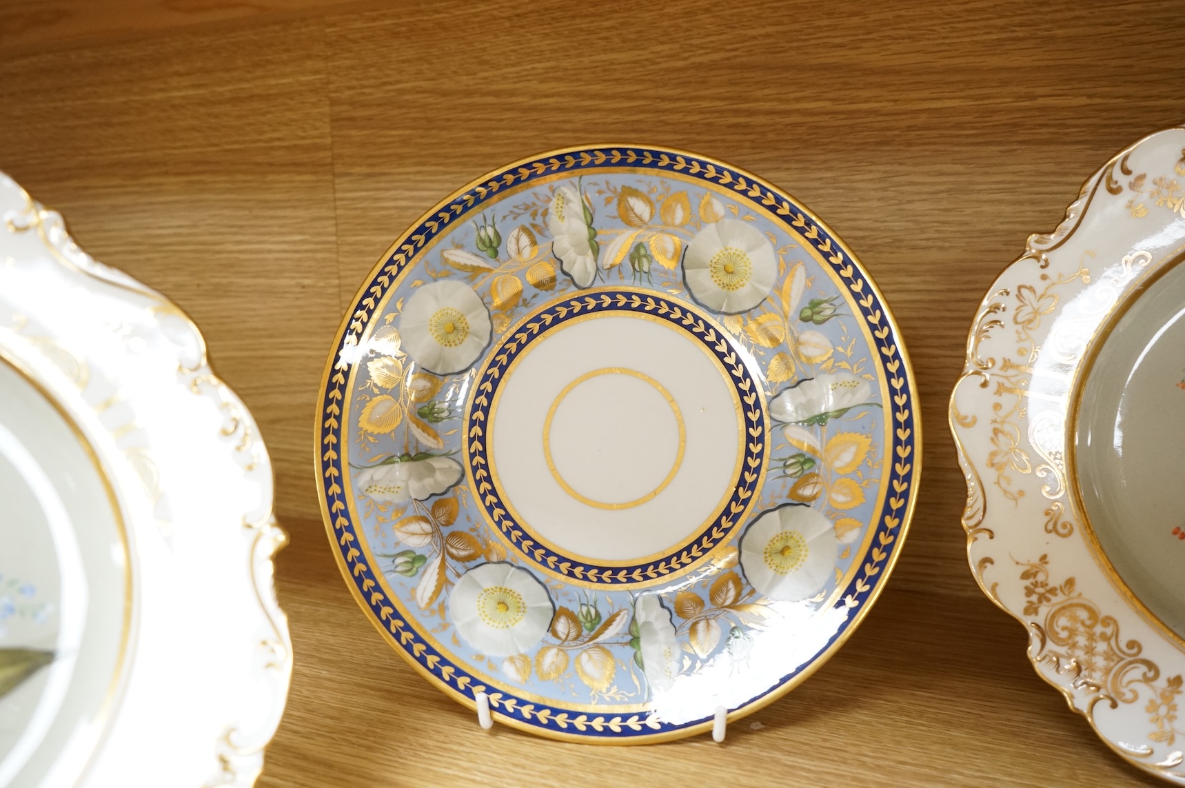 Two pairs of early 19th century porcelain botanical dishes, largest 22cm in diameter